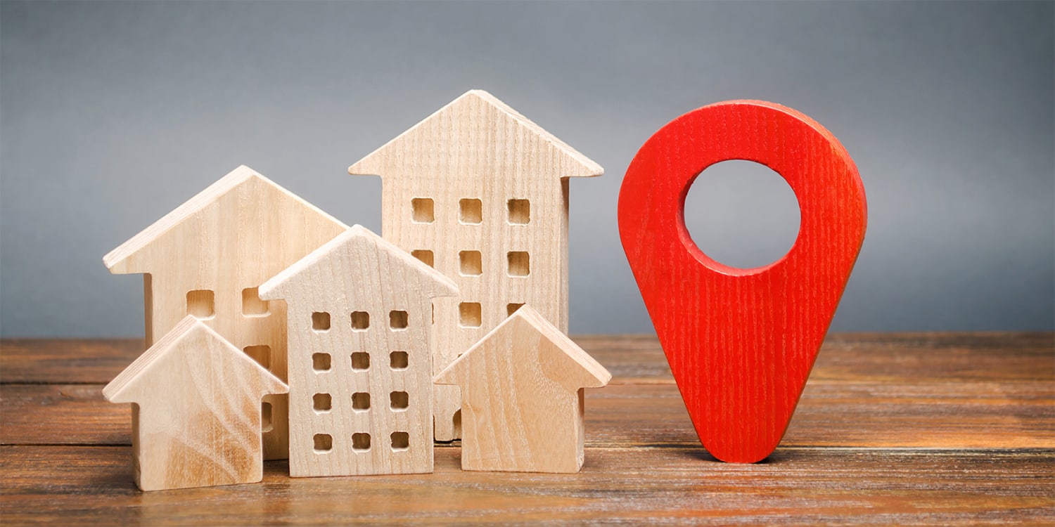 Buying houses, location concept with wood houses and map point